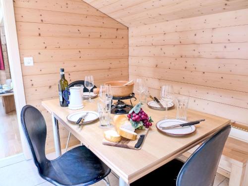a wooden table with wine glasses and food on it at Apartment Bühl by Interhome in Achseten
