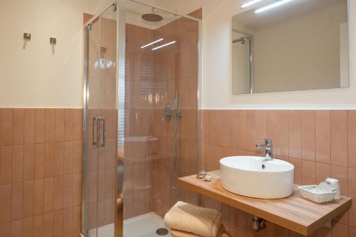 a bathroom with a sink and a shower at Hotel Dimorae Rooms and Suites - Apartments in Civitanova Marche