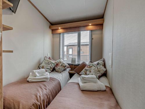 two beds in a room with a window at 2 Bed in St Andrews 95035 in St. Andrews