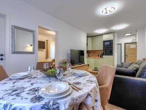 a dining room with a table with plates and wine glasses at Apartment Darja by Interhome in Novigrad Istria