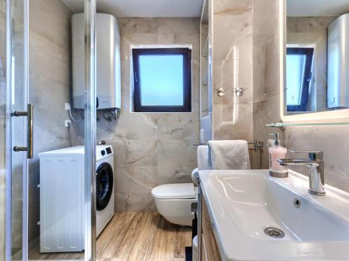 a bathroom with a sink and a washing machine at Apartment Darja by Interhome in Novigrad Istria
