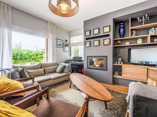 a living room with a couch and a tv at Villa Villa Guidel Plages by Interhome in Guidel