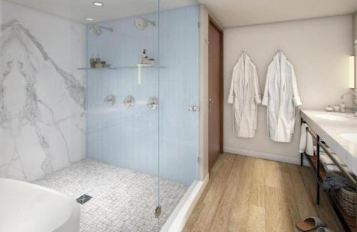 a bathroom with a shower and a sink at Delamar Traverse City in Traverse City