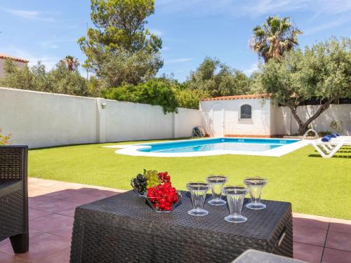 a table with wine glasses and flowers on it at Holiday Home Salze by Interhome in Hospitalet de l'Infant