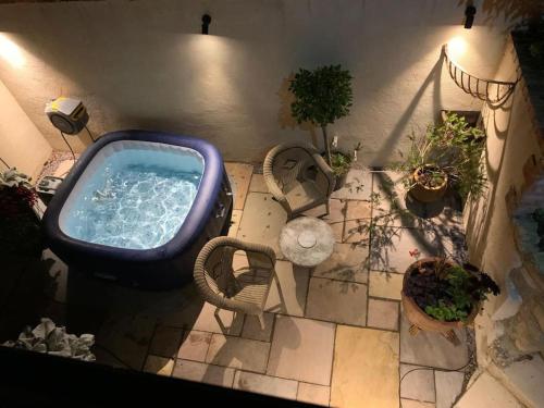 an overhead view of a bath tub in a room with plants at The Nest in Gloucestershire