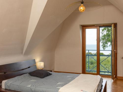 a bedroom with a bed and a large window at Holiday Home Brise Marine by Interhome in Cancale