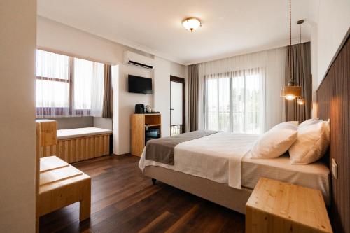a hotel room with a bed and a bathroom at Rodones 1924 in Urla