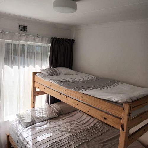a bunk bed in a room with a window at Ramsgate Beachfront - Ramsgate Palms AA 50 in Margate