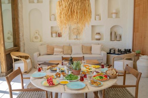a table with food on it in a living room at Alya Country in Turunc