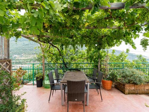 a patio with a table and chairs under a pergola at Holiday Home Ca da Nair by Interhome in Castellaro