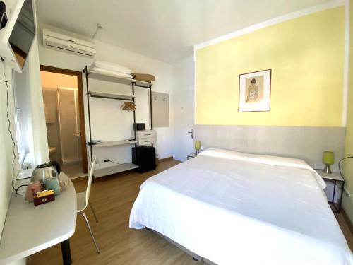 a bedroom with a large white bed in a room at Hotel Alpino in Malcesine