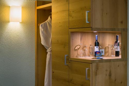 a bathroom with a sink with a bottle of wine at Ringhotel Mönch`s Waldhotel in Unterreichenbach