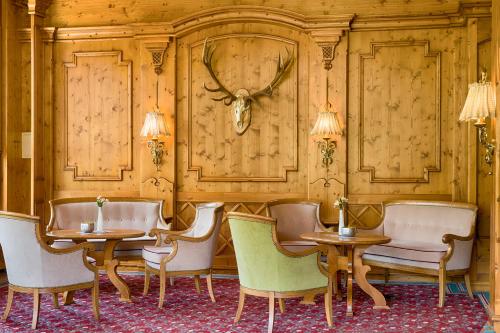 a dining room with chairs and a table with antlers on the wall at Ringhotel Mönch`s Waldhotel in Unterreichenbach