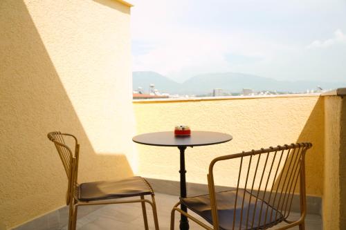 a small table and two chairs on a balcony at Haris Apartments Tirana in Tirana