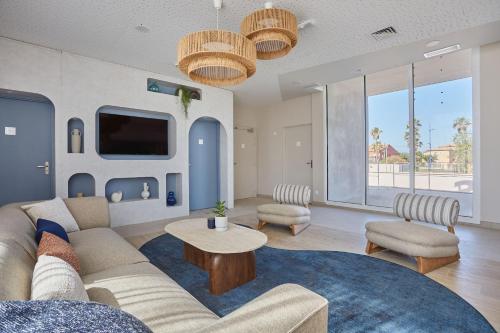 a living room with a couch and a table at Résidence Odalys Riviera in Hyères