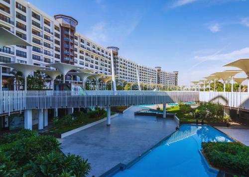 a view of a resort with a bridge over a pool at Porto New Cairo - بورتو نيو كايرو in Cairo