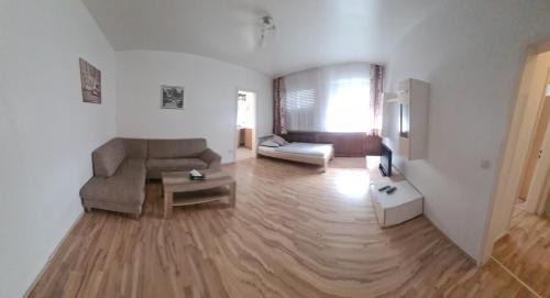 a living room with a couch and a table at Hotel Zur Aue in Wesel