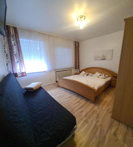 a bedroom with two beds and a window at Hotel Zur Aue in Wesel