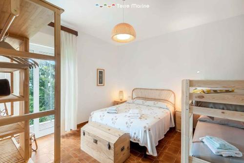 a bedroom with a bunk bed and a bunk bed at Maison Ro, TerreMarine in Vezzola