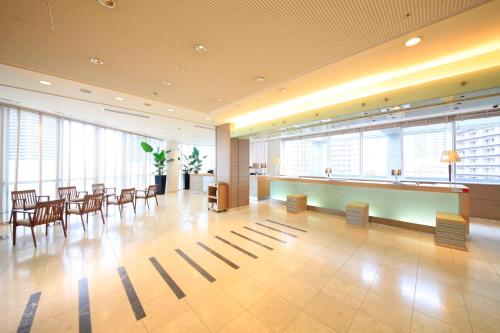 a lobby with chairs and a bar in a building at Richmond Hotel Premier Musashikosugi in Kawasaki