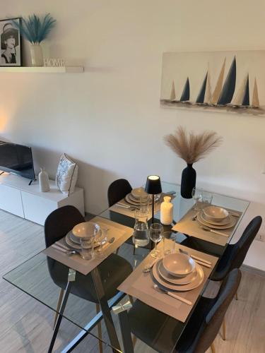 a dining room table with chairs and plates on it at Bilocale nuovo - Basiglio Humanitas in Basiglio