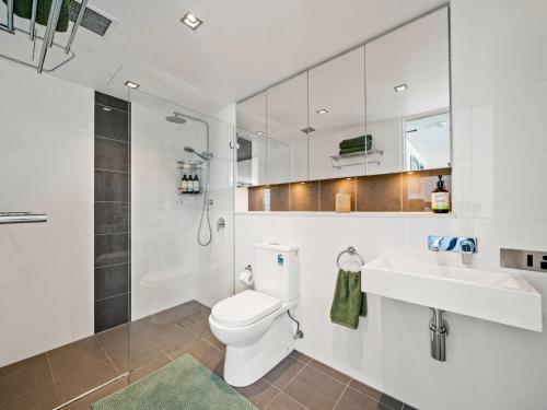 a bathroom with a toilet and a sink and a shower at XQ Collection La Casa De Frida - Modern Studio with Balcony in Sydney