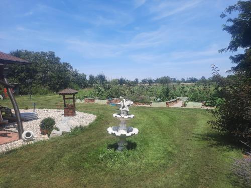 a fountain in the middle of a grass field at Bačalandia- relax na samote in Veľká Dolina