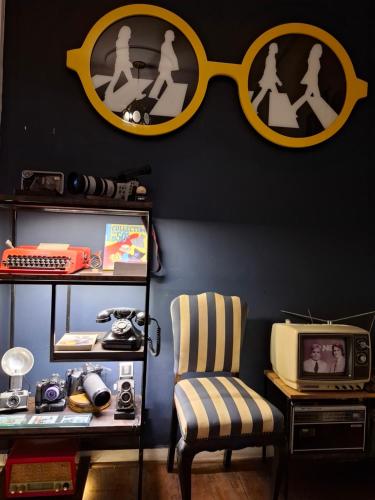a room with a desk with a pair of glasses on the wall at Casarão Petrópolis Vintage - Hostel & Suítes in Petrópolis
