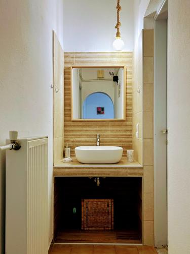 a bathroom with a sink and a mirror at Bralos Apartments in Patitiri