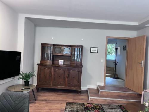 a living room with a large wooden entertainment center at Altstadt-Quartier in Stendal