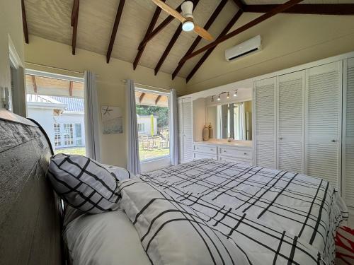a bedroom with a large bed and a large window at Beachwalk Becune in Cap Estate