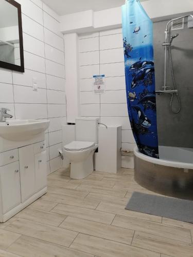 a bathroom with a toilet and a sink and a tub at 3Rooms Wrzeszcz in Gdańsk