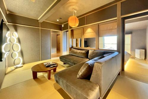 a living room with a couch and a table at 鵜原館 -Ubarakan- in Katsuura
