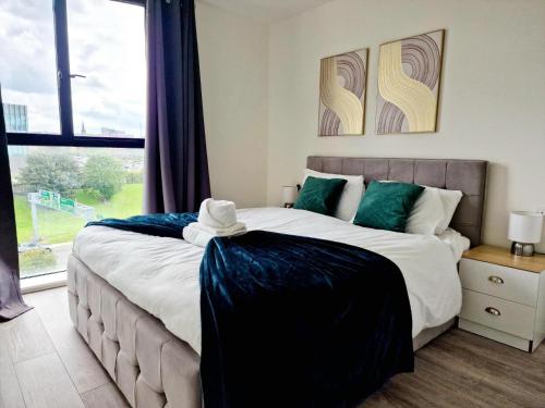 a bedroom with a large bed and a large window at Westminster Luxury Liverpool Apartment with Free Parking in Liverpool
