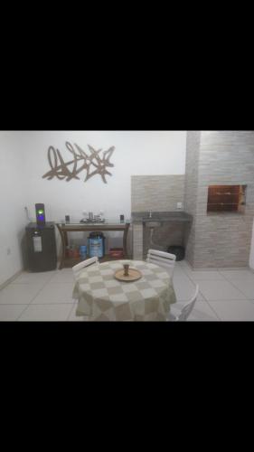 a living room with a table and two chairs at Casa com Piscina e Ar Condicionado in Imbé