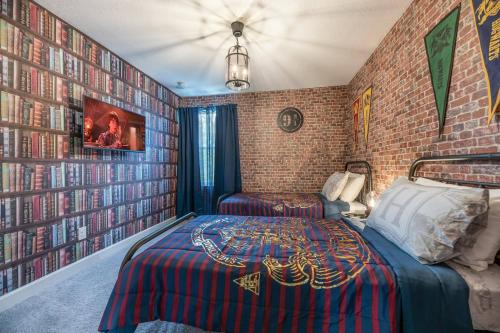 a bedroom with a bed and a brick wall at 8005 Stunning Villa Disney Park Proximity in Orlando