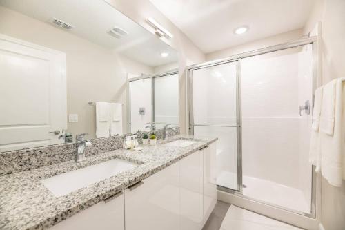 a bathroom with two sinks and a shower at 8005 Stunning Villa Disney Park Proximity in Orlando