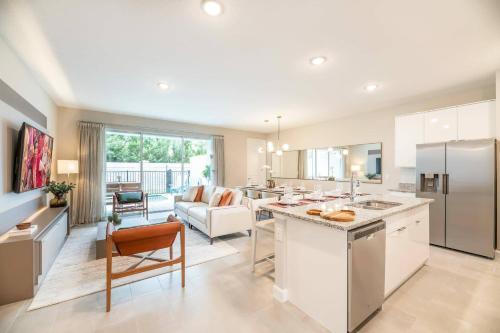 a kitchen and living room with a couch and a table at 8005 Stunning Villa Disney Park Proximity in Orlando