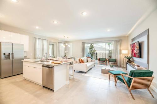 a kitchen and living room with a couch and a table at 7992 Cozy 5BD Disney Getaway with Pool in Orlando