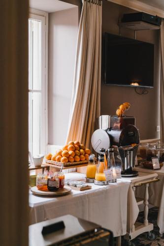 a table with oranges and other food on it at Chateau du Clos de la Ribaudiere - Teritoria in Chasseneuil-du-Poitou