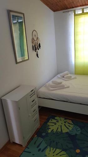 a room with two beds and a cabinet and a rug at Igalo Vuke in Igalo