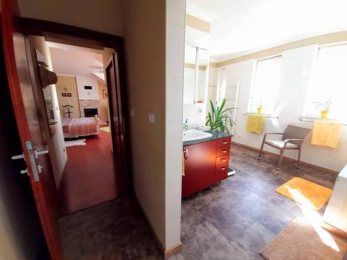 a room with a sink and a bathroom at Canadian style house with 3D effect pool in Vinosady