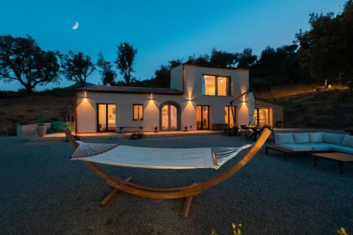 a house with a hammock in front of it at Villa Andrea in Cefalù
