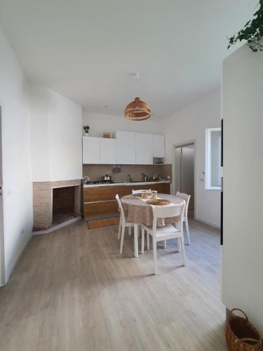 a kitchen and dining room with a table and chairs at Salento31 in Collepasso