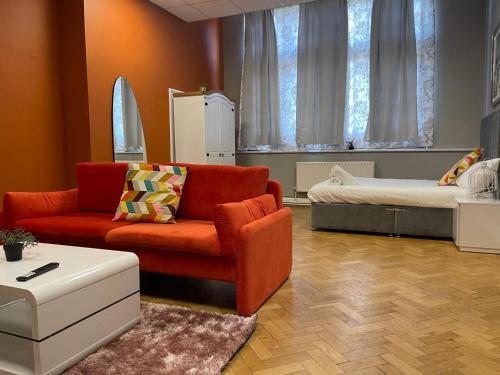 a living room with a couch and a bed at Bessemer Rooms in Sheffield