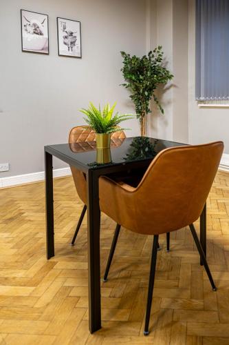 a black table and a chair with plants on it at Bessemer Rooms in Sheffield