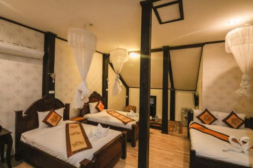 Ένα ή περισσότερα κρεβάτια σε δωμάτιο στο Ananta Hotel Luangprabang