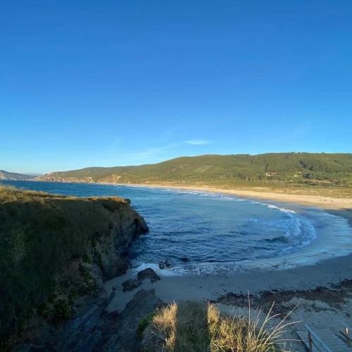 a view of a beach with the ocean at Casa do Souto in Ferrol