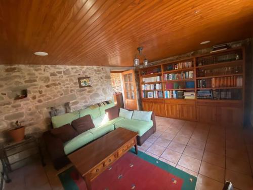 a living room with a couch and some books at Casa do Souto in Ferrol