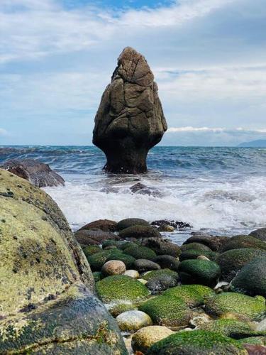 a large rock in the middle of the ocean at Casa do Souto in Ferrol